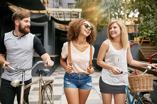 Group of Friends with Bikes Commuting to Campus
