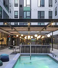 Courtyard with lounge, hot tub, outdoor TVs, and grills