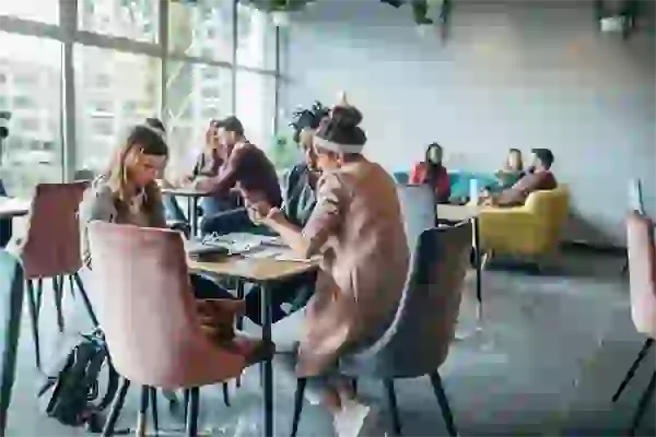 Twin Cities students huddled together working at table